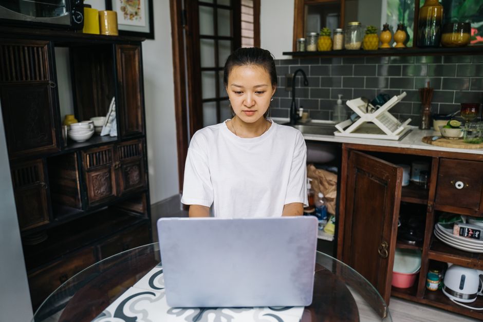A woman using a laptop at home